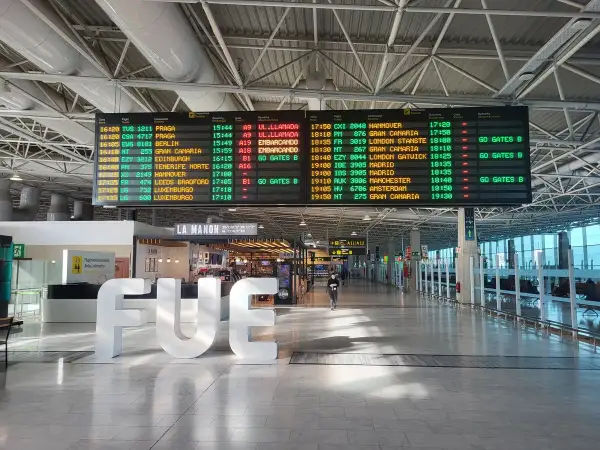 Tablica odlotów na lotnisku pokazuje, co po kolei na lotnisku: loty do Pragi, Berlina, Hanoweru, Edynburga, Londynu, Madrytu, Manchesteru, Amsterdamu i Gran Canarii.